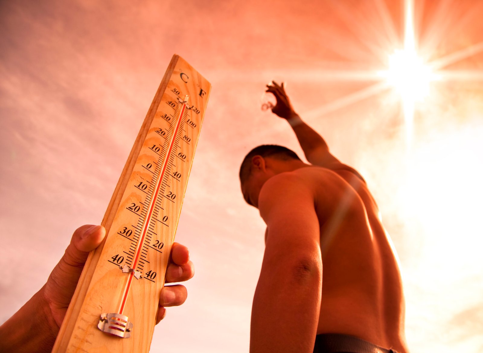 man throwing water for cooling temperature and hand holding thermometer under heat weather