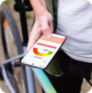 person holding a phone open to the Zelus system app