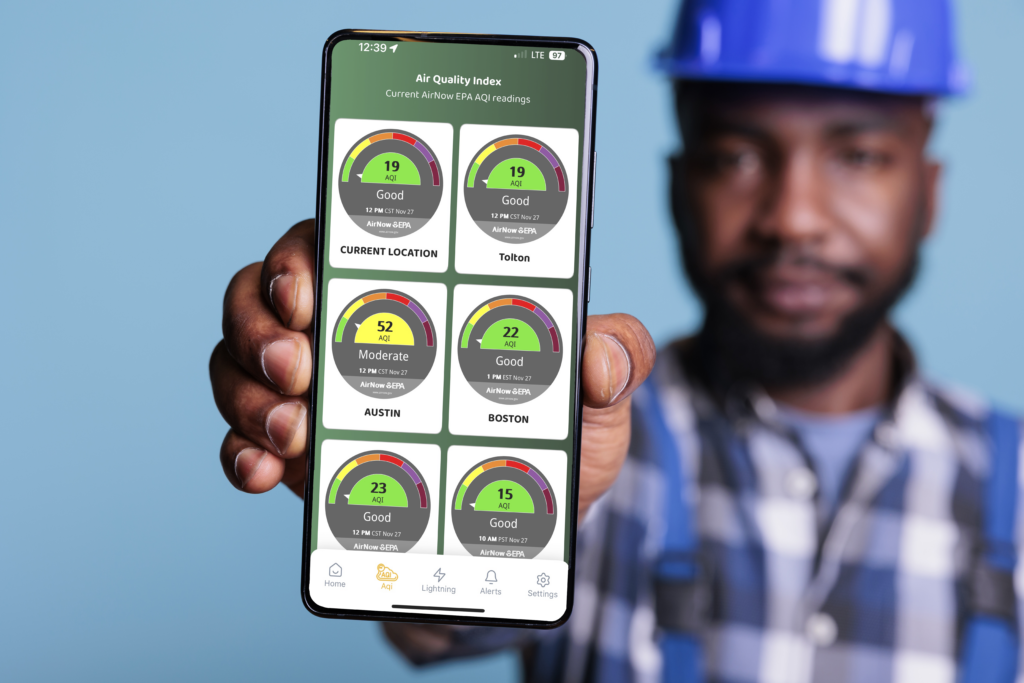 Construction worker holding a phone with Zelus AQI