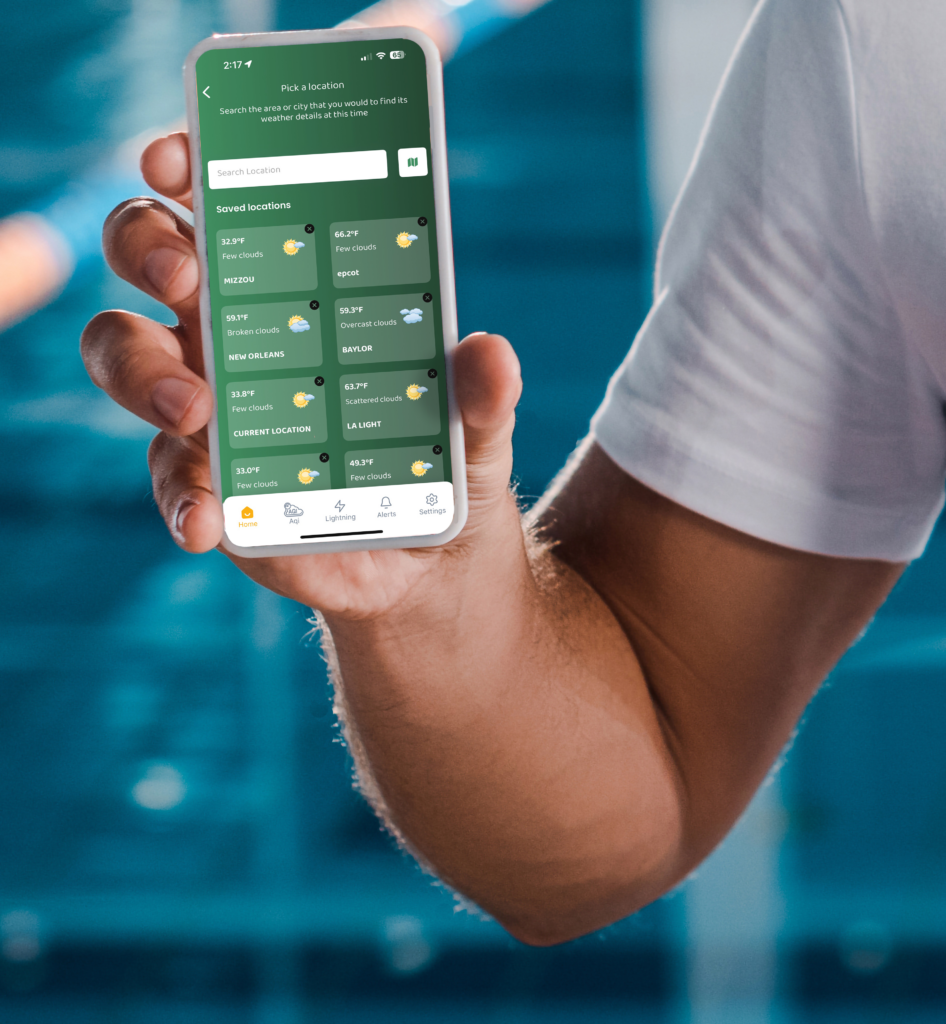 A man's hand holding the Zelus system app showing saved locations.