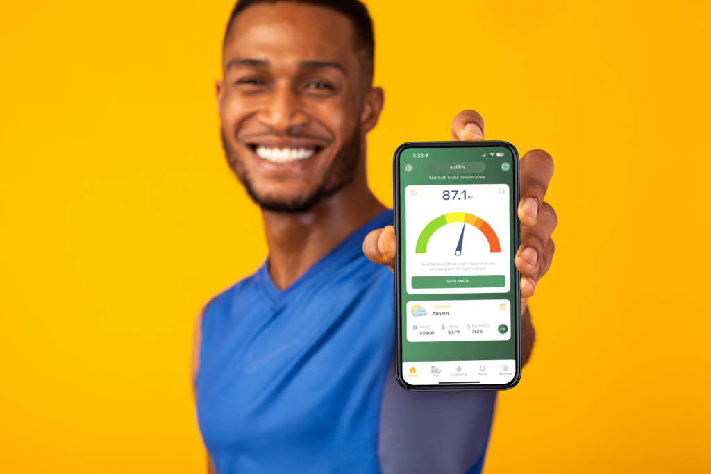 A black man holding a phone with the Zelus system app home screen showing.
